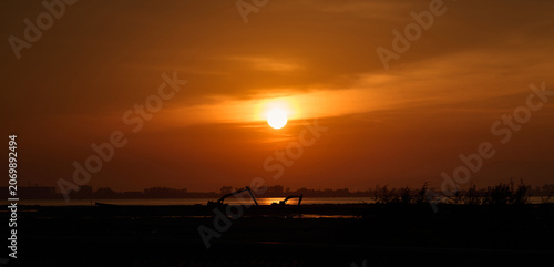 Silhouette of Excavators at Sunset Along Coastal Construction Site
