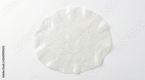 Top view flat lay of a single translucent rice paper sheet on white background