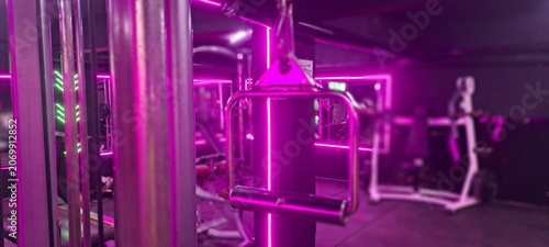 Gym interior with vibrant pink neon lighting