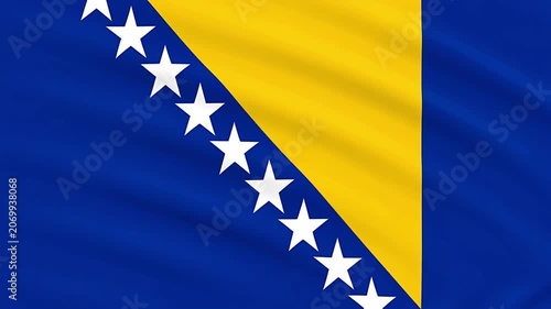 A close up of the national flag of Bosnia and Herzegovina waving.