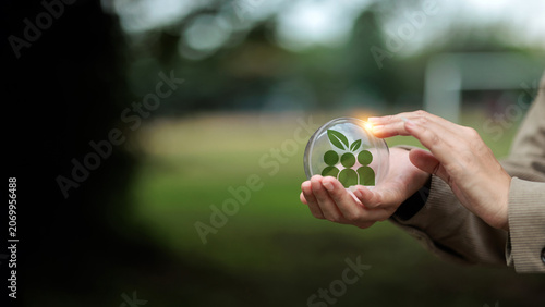 Hands Protecting Glass Ball with People and Leaf Icon