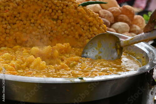 Konstfotografi Pani puri stall with a large mound of seasoned yellow peas sits