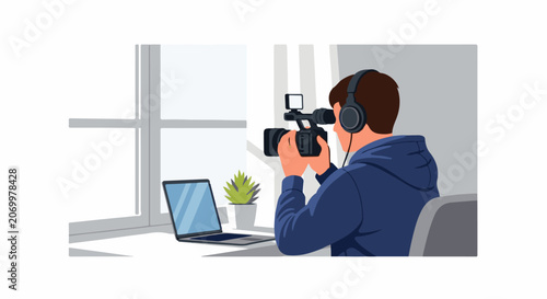 Person with headphones records with a video camera at a desk with a laptop and plant