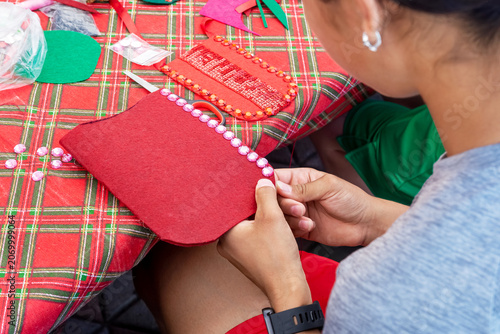 The young woman crafts exquisite ornaments using felt and beads.
