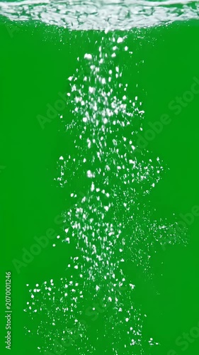 Water bubbles rising against a bright green background.
