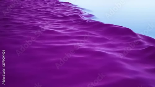 Purple sand meets blue water edge.