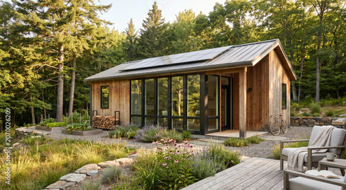 Small wooden cabin with solar panels in a lush forest setting