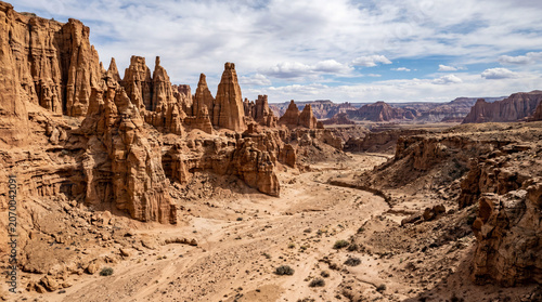 Wide Desert Canyon Ravine Featuring Dramatic Natural Rock Pillars And Spires Along Its Outer Edge