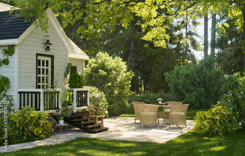 Obraz na plátně Charming garden cottage with patio seating in a lush sunlit backyard