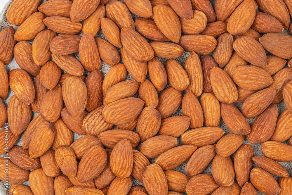 Fototapeta premium Raw almonds background texture top view