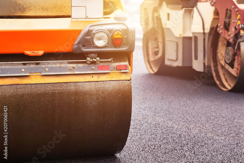 Fotografie Busy Asphalt Paving Works on Urban Street Road During Daylight Hours