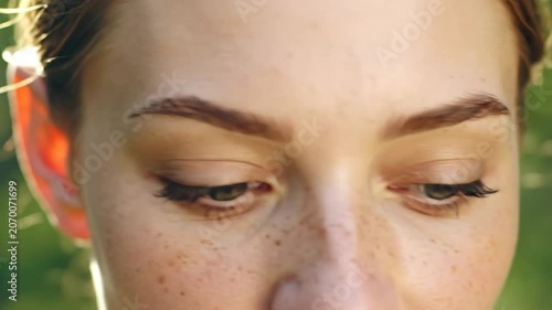 A close up portrait of a young woman with green eyes