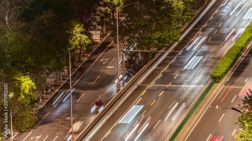 Urban nighttime road traffic flow light trail time-lapse video