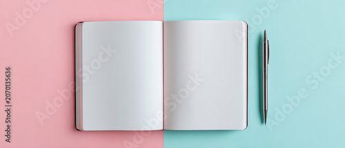 Minimalist flat lay of an open blank notebook and pen on split pink and blue background, ideal for creativity, planning, or education concepts.