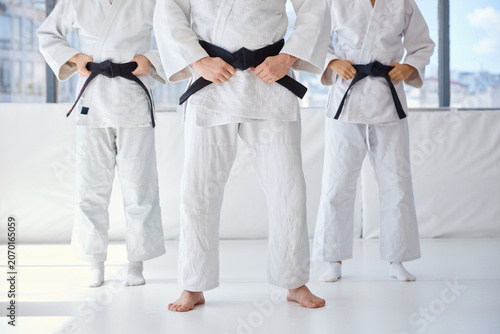 Photos Martial artists position themselves in synchronized control showing discipline a
