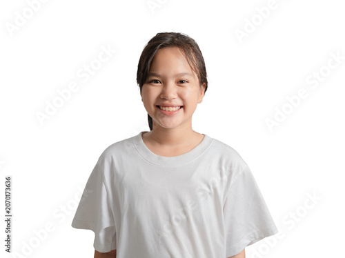 Cuadro en lienzo Young girl standing and smiling with a cheerful expression, capturing happiness,
