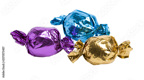 Photos Three colorful foil-wrapped candies purple gold, and blue