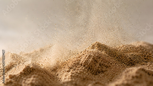 Fine vanilla powder splashing in the air with macro detail
