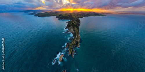 Valokuva The stunning sunrise over the cliffs and headlands, Nugget Point, New Zealand