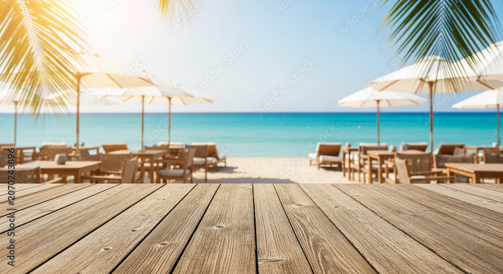Fototapeta premium Wooden foreground with beach cafe, loungers, and umbrellas facing a turquoise ocean under a sunny sky, symbolizing relaxation and vacation