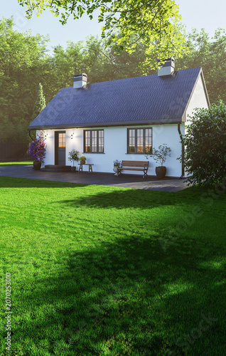 Charming white cottage with garden and lawn in sunlight