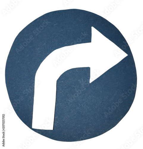 A circular blue traffic sign featuring a bold black arrow pointing right
