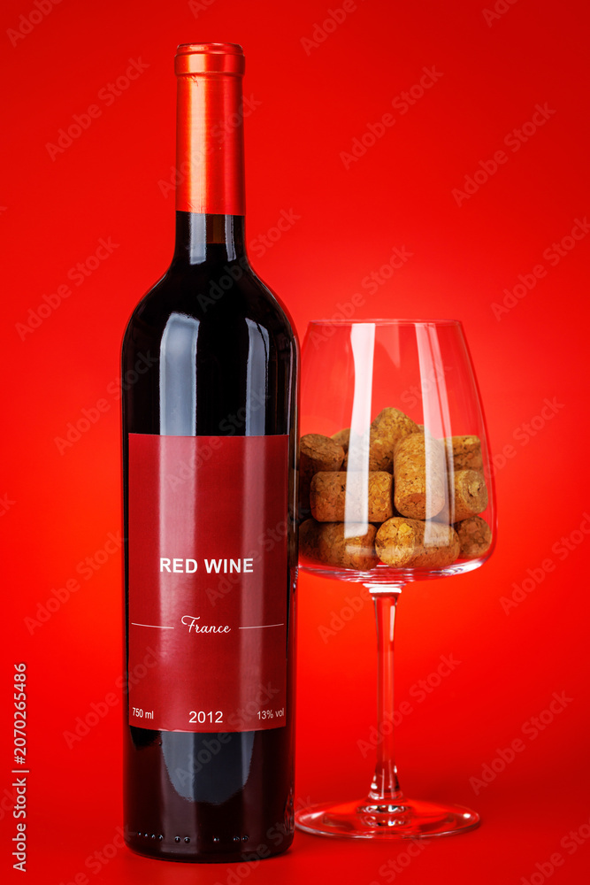 Fototapeta premium Red wine bottle mockup on red background