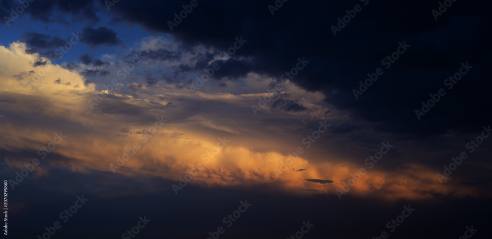 Fototapeta premium Sunset sky with orange clouds. Nature background.