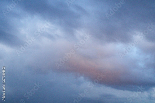Konstfotografi Cloudy sky subtle color transition from deep blue to warm pink, clouds in muted