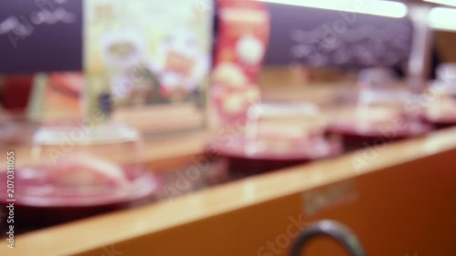 Abstract blur sushi on conveyor belt in Japanese kaiten sushi restaurant