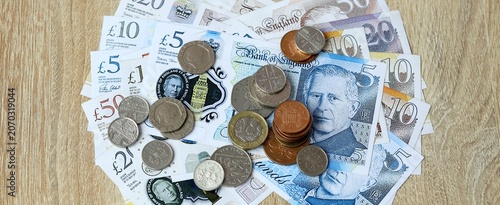 British pound money bills and coins on table. United Kingdom cash of GBP currency close up