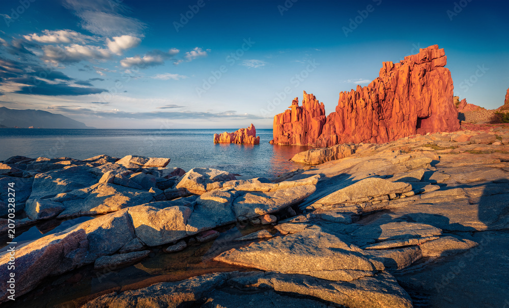 Naklejka premium Colorful evening view of Arbatax resort. Majestic summer seascape of Mediterranean sea with Red Rock. Stunning outdoor scene of Sardinia island, Italy Europe. Beauty of nature concept background.