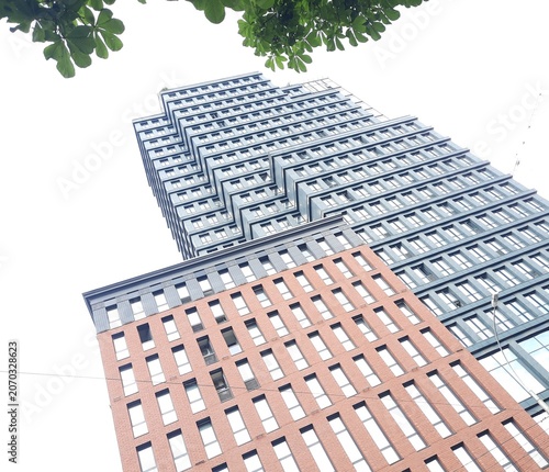 Modern skyscraper residential building exterior under sky view from below