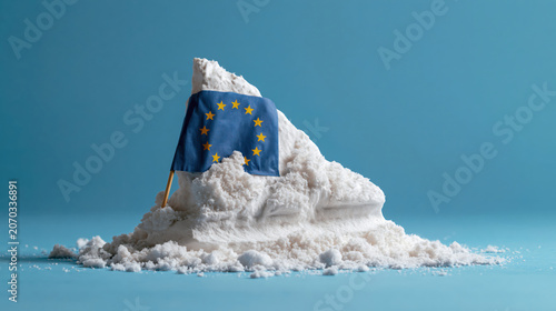 An iceberg in a blue studio setting is partially covered with a fracture of the flag of the European Union. Concept of Greenland's citizens are EU-citizens.