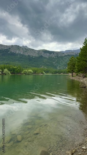 Scenic Forest Lake Timelapse: Shimmering Water and People Fishing