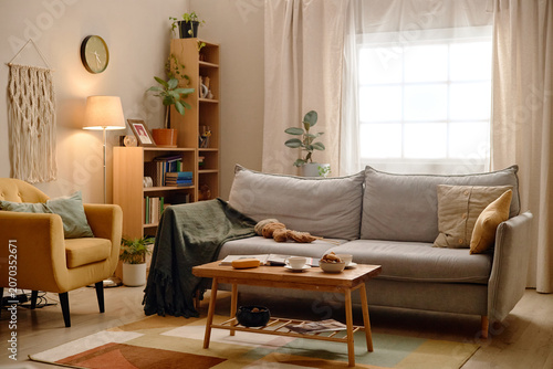 Konstfotografi Wide angle shot of living room featuring sofa, armchair, coffee table, plants, w