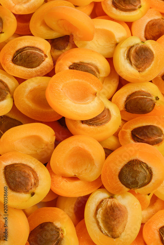 Ripe juicy orange apricots slices fruit background.