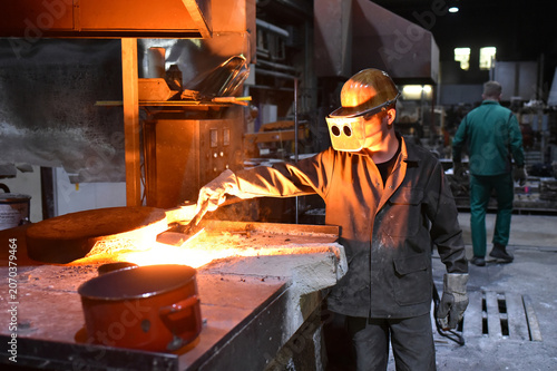 Принти на полотні young worker in protective clothing at work at the blast furnace in an iron foun