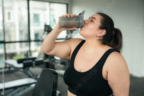 Bild auf Leinwand Plus Size Woman Drinking Protein Shake After Gym Workout, Healthy Lifestyle and