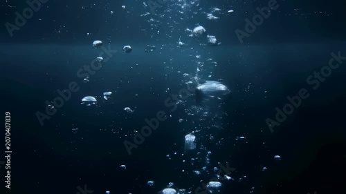 Bubbles rising through dark water, creating a serene underwater atmosphere. Represents tranquility and the beauty of aquatic environments