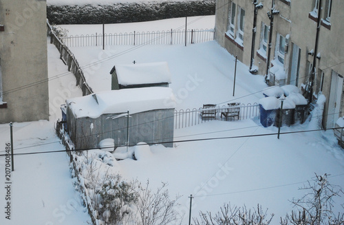 Фотография Winter View of Snow Covered Residential Buildings and Gardens