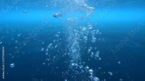 Bubbles rising through clear blue water, creating a serene underwater atmosphere. Represents tranquility and the beauty of aquatic environments