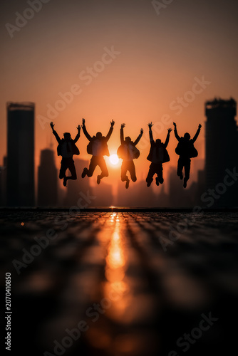 Work Life Joy, Colleagues jump outdoors under warm sunlight, reflecting work-life balance, joy, and a healthy lifestyle.