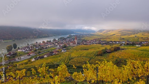 Autumn morning time lapse clouds moving over of Weisenkirchen in der Wachau town and vineyards. Wachau valley, Austria.