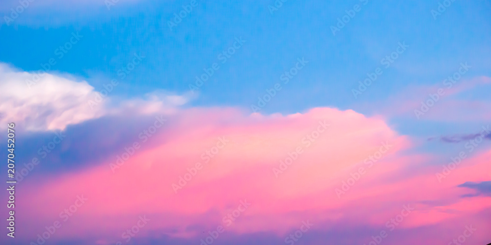 Fototapeta premium Vibrant Pink Clouds on Pastel Blue Sky at Sunset 