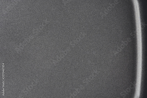 Fotografie A close up full frame shot captures the dark grey matte textured surface of a non stick coating inside a baking pan