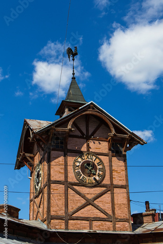 Historic Old Town Hall, featuring distinctive timber-framed architecture, a prominent clocktower, and a traditional rooster weather vane above the town square.