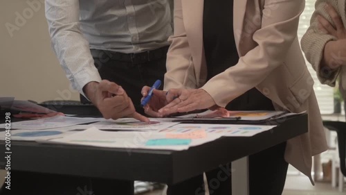 Professional business team analyzing financial documents in office meeting finance analysis data chart report