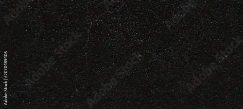 Panel kuchenny z motywem Black granite texture with subtle white speckles, polished dark stone surface background, elegant charcoal marble slab for kitchen countertop design