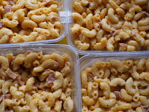 Macaroni and cheese in containers.
